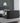 A double-sized Ottoman TV bed with a grey fabric headboard and storage ottoman with a 43" Tv Capacity